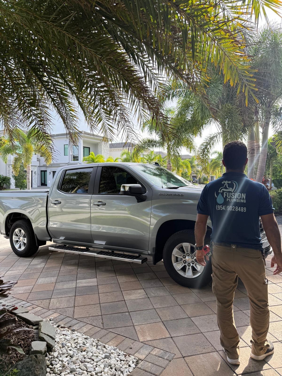Fusion Plumbing technician arriving in the branded truck